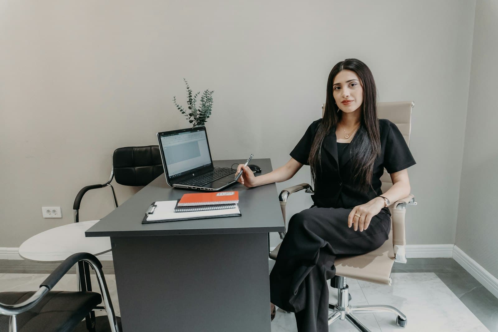 Professional working at a desk with a laptop